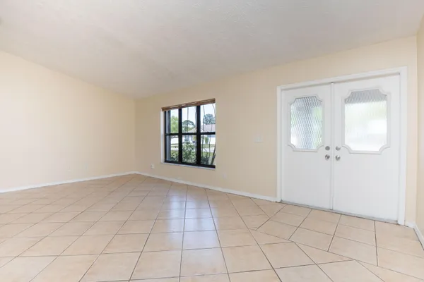 an empty room with windows and closet