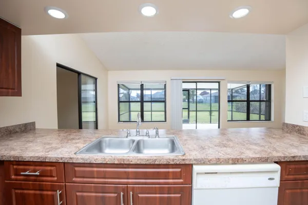a kitchen with stainless steel appliances granite countertop a stove sink and cabinets