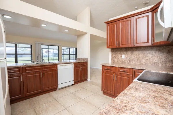 a kitchen with a refrigerator and a sink