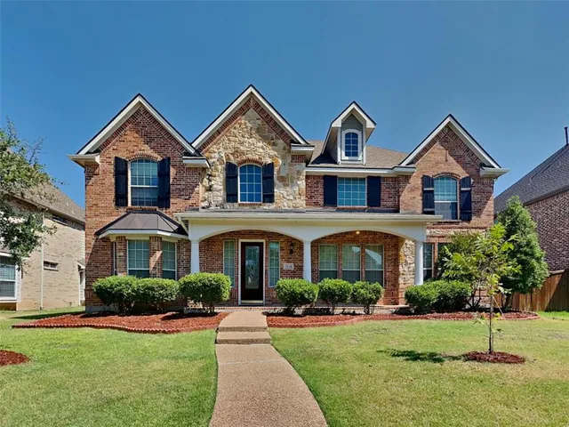 front view of residential houses with a yard