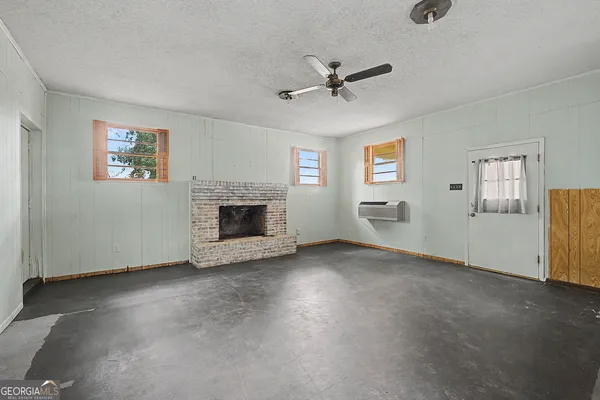 a view of empty room with window and fireplace
