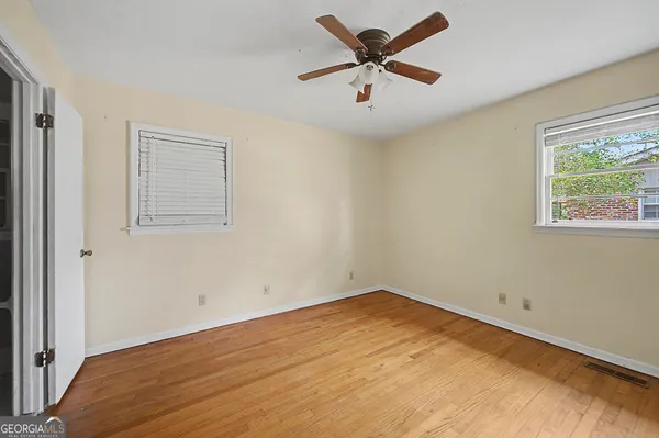 wooden floor in an empty room with a window