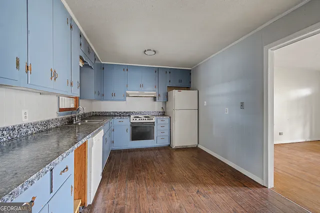 a kitchen with cabinets and stainless steel appliances