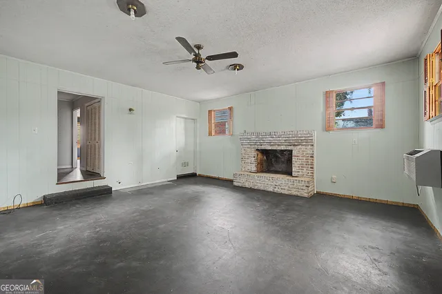 a view of empty room with fireplace