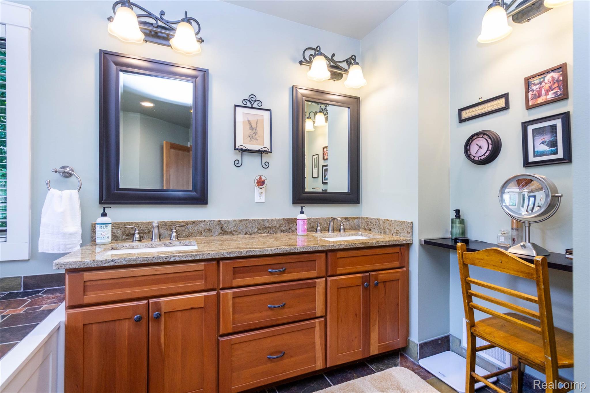 9887 Hadley Road Clarkston, MI 48348 - Photo 21 of 56 Bathroom vanity featuring a dual-sink wood-finish cabinet with a stone countertop