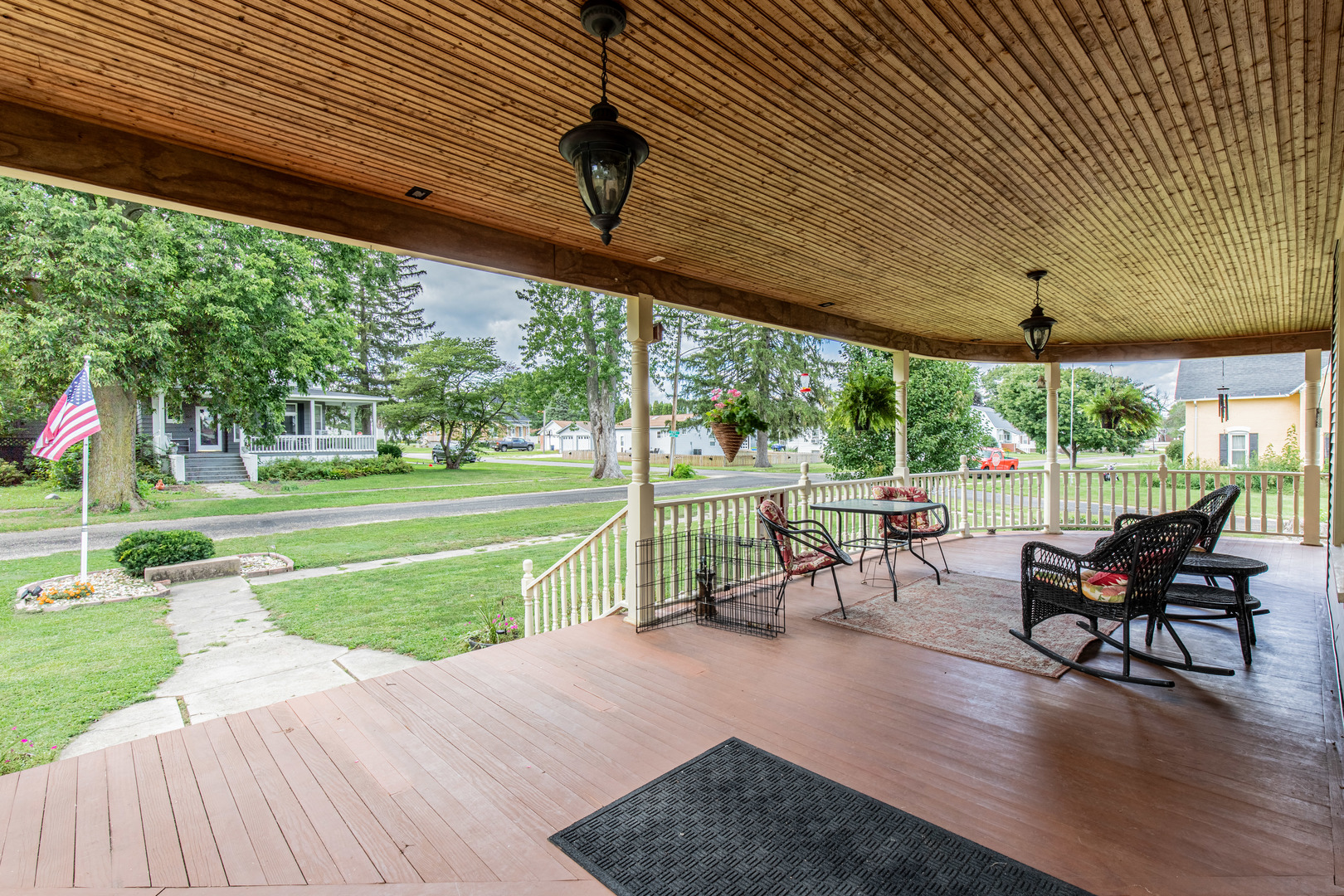304 Locust Street Mineral, IL 61344 - Photo 8 of 38 a view of a patio with table and chairs potted plants with wooden floor and fence