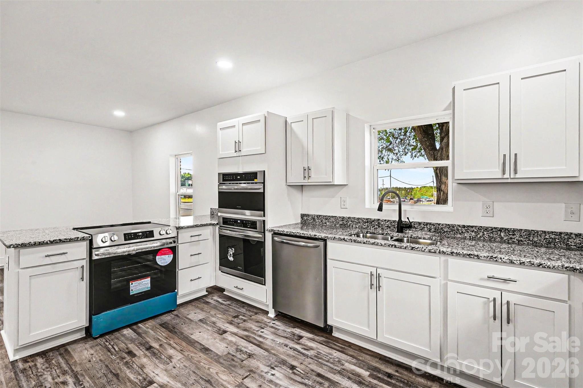 405 Aquadale Road Albemarle, NC 28001 - Photo 13 of 29 a kitchen with granite countertop cabinets stainless steel appliances and a sink