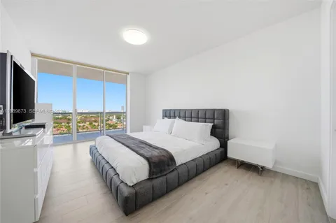 a room with a chair and white walls