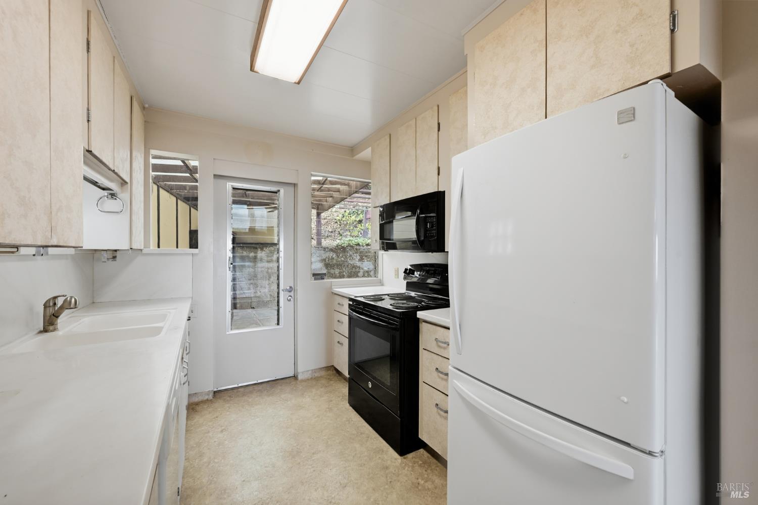 666 Redwood Avenue Corte Madera, CA 94925 - Photo 25 of 43 a kitchen with stainless steel appliances a refrigerator sink and stove