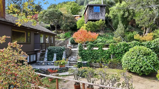 a view of backyard with outdoor seating and green space