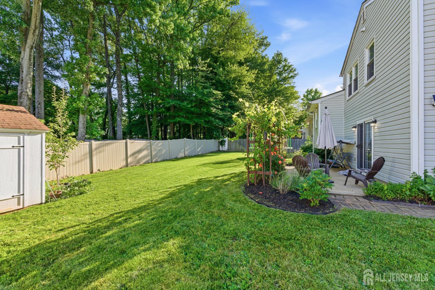 5 McKinley Street Edison, NJ 08820 - Photo 34 of 38 a view of backyard with table and chairs and wooden fence
