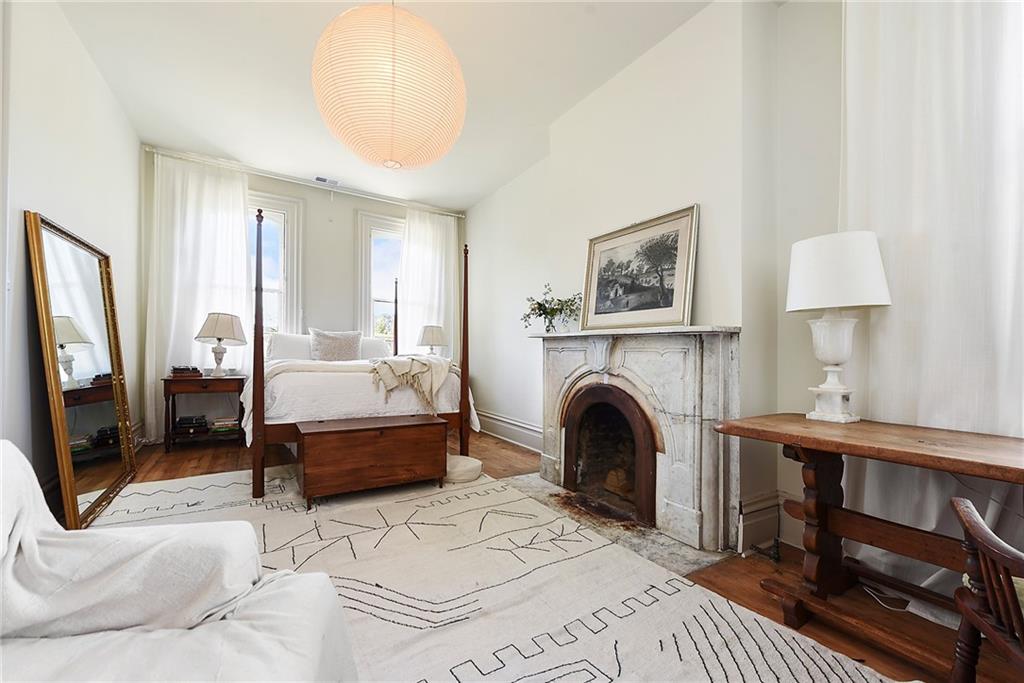 1426 Chateau Street Pittsburgh, PA 15233 - Photo 23 of 45 a spacious bedroom with a large bed and a chandelier