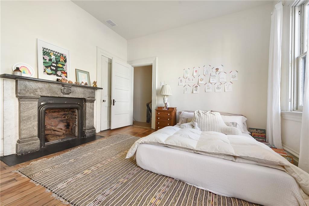 1426 Chateau Street Pittsburgh, PA 15233 - Photo 29 of 45 a bedroom with a bed and a fireplace
