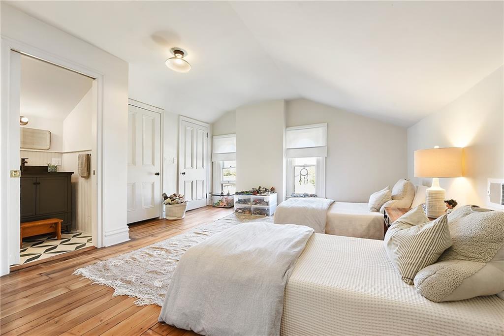 1426 Chateau Street Pittsburgh, PA 15233 - Photo 33 of 45 a large bedroom with a bed and wooden floor