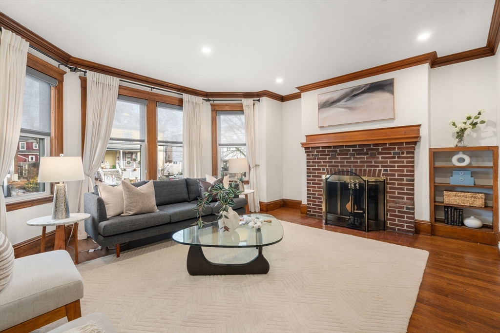 378 School Street, Unit 1 Watertown, MA 02472 - Photo 2 of 23 a living room with furniture large window and a fireplace