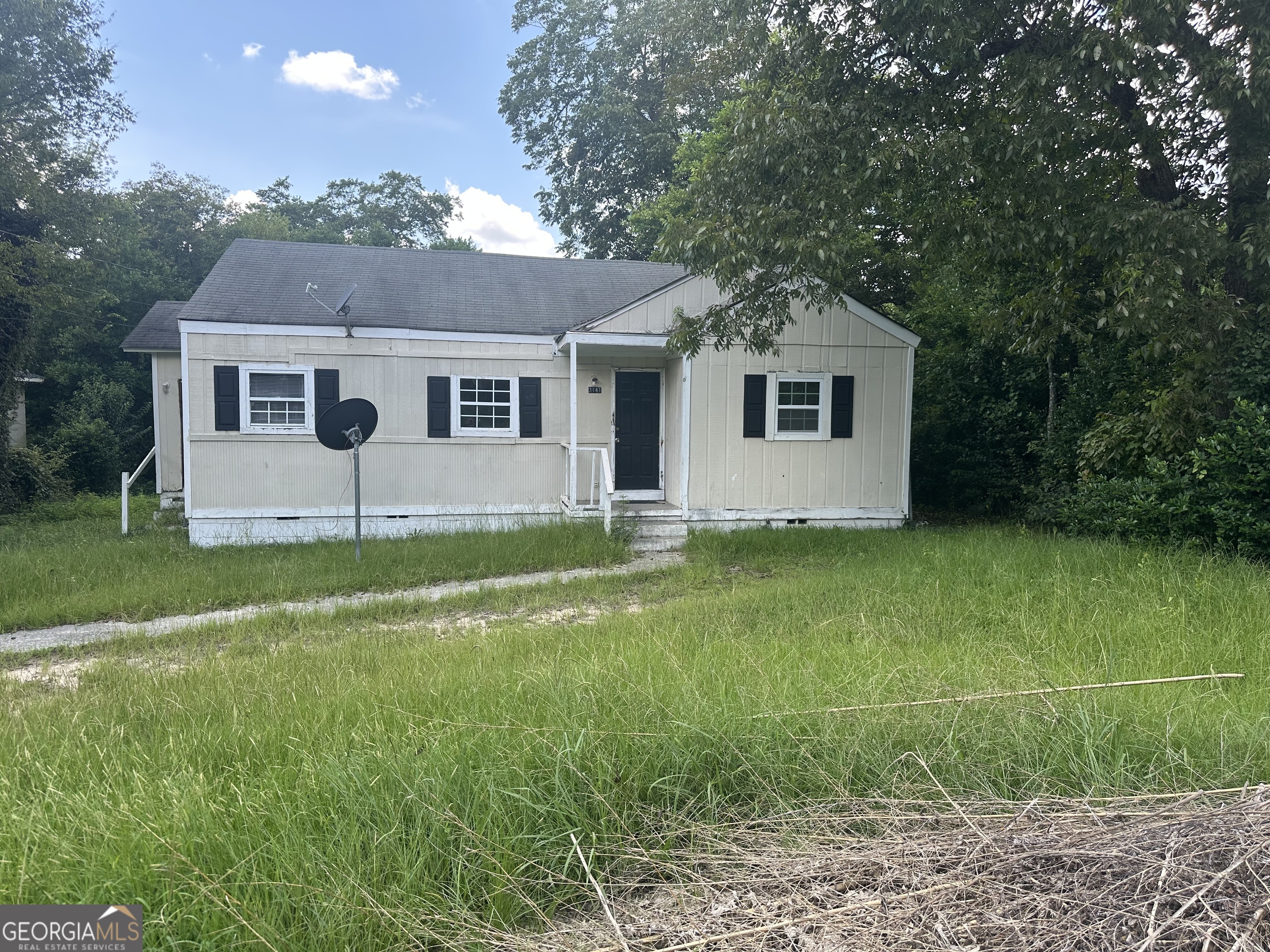 a front view of house with yard and green space