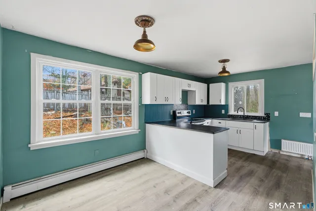 a kitchen with a sink and wooden floor