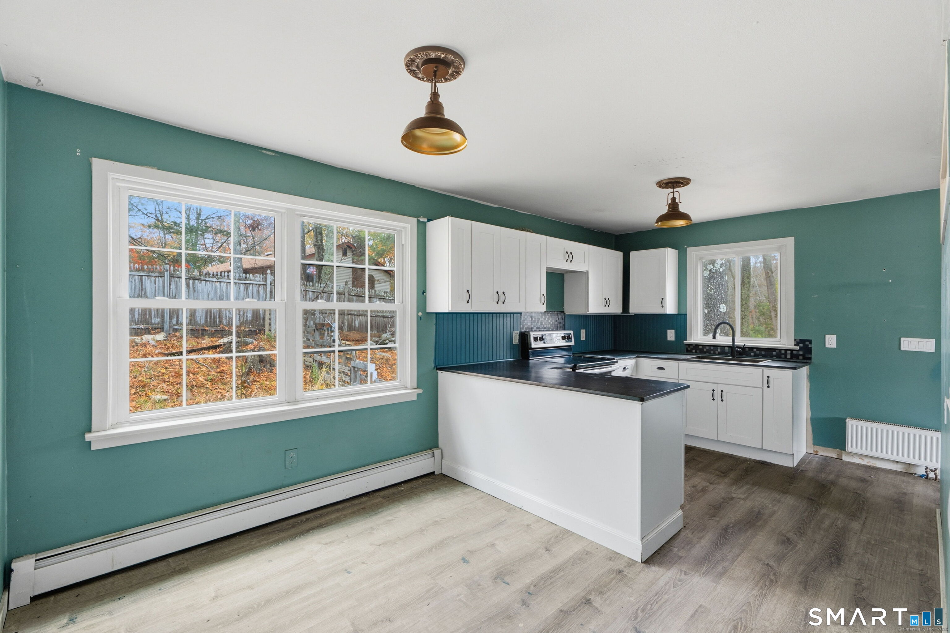 487 Buff Cap Road Tolland, CT 06084 - Photo 11 of 22 a kitchen with a sink and wooden floor