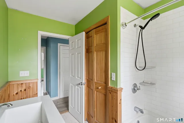 a bathroom with a granite countertop shower and a sink