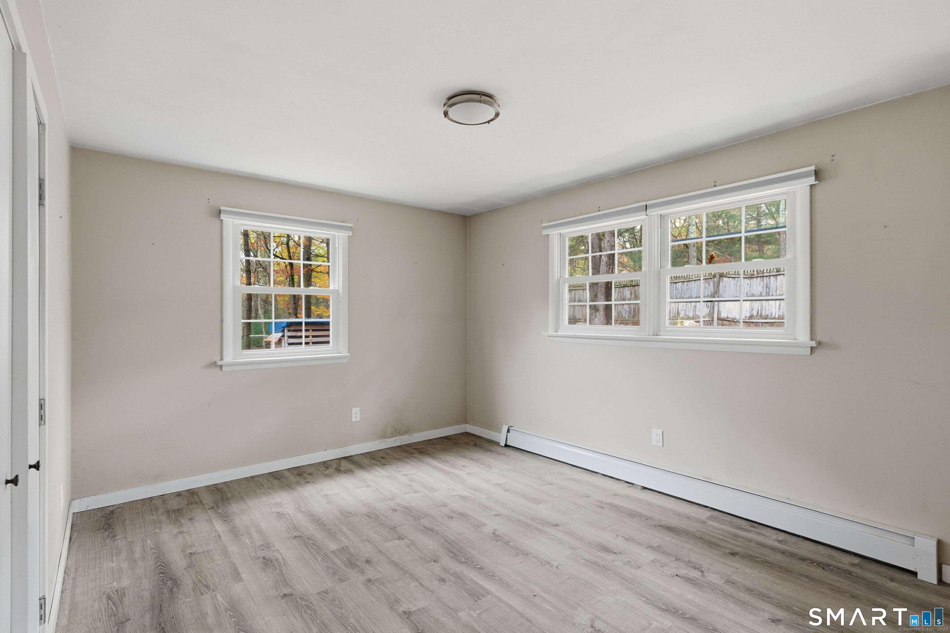 487 Buff Cap Road Tolland, CT 06084 - Photo 16 of 22 an empty room with wooden floor and windows