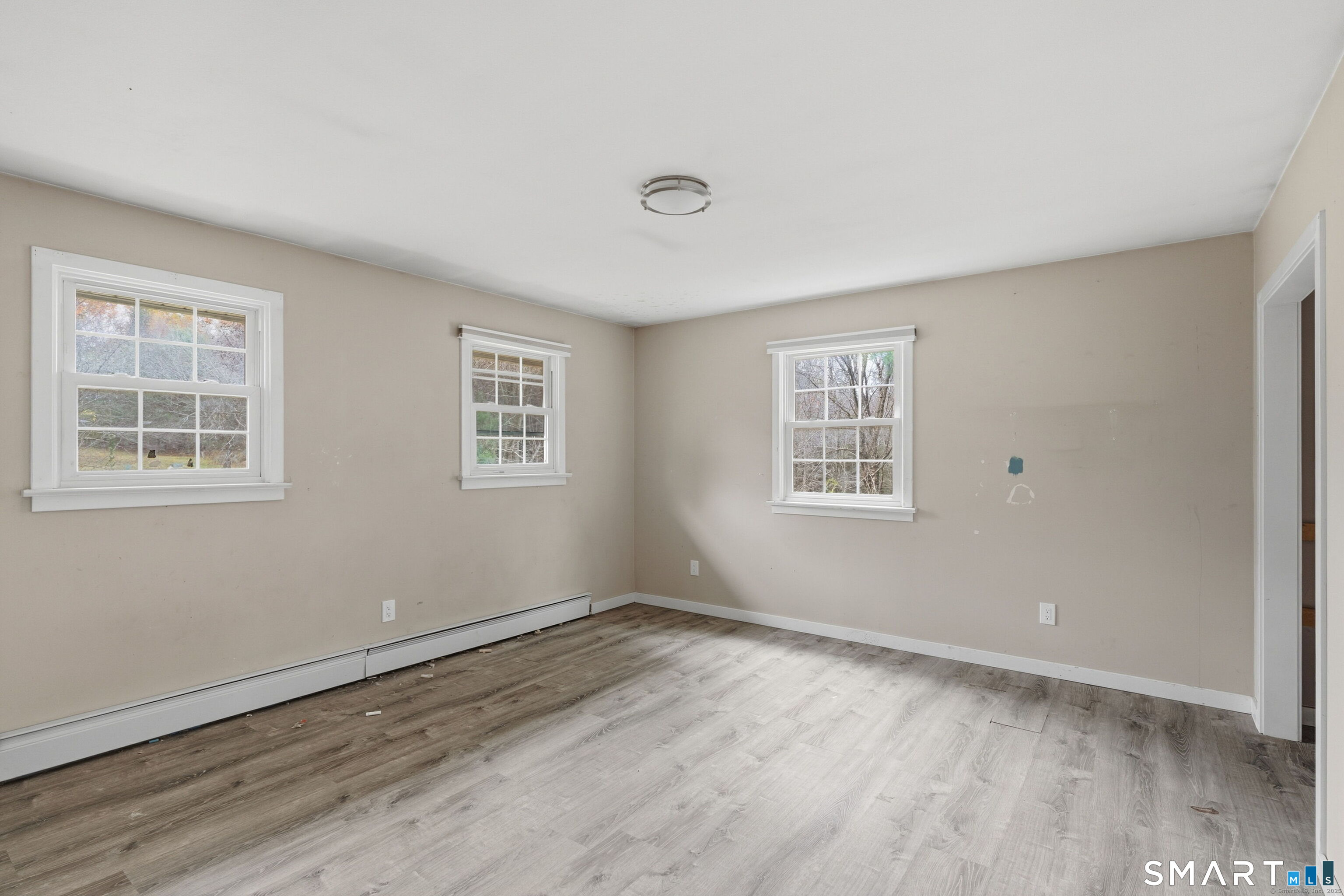 487 Buff Cap Road Tolland, CT 06084 - Photo 18 of 22 a view of a room with wooden floor and windows
