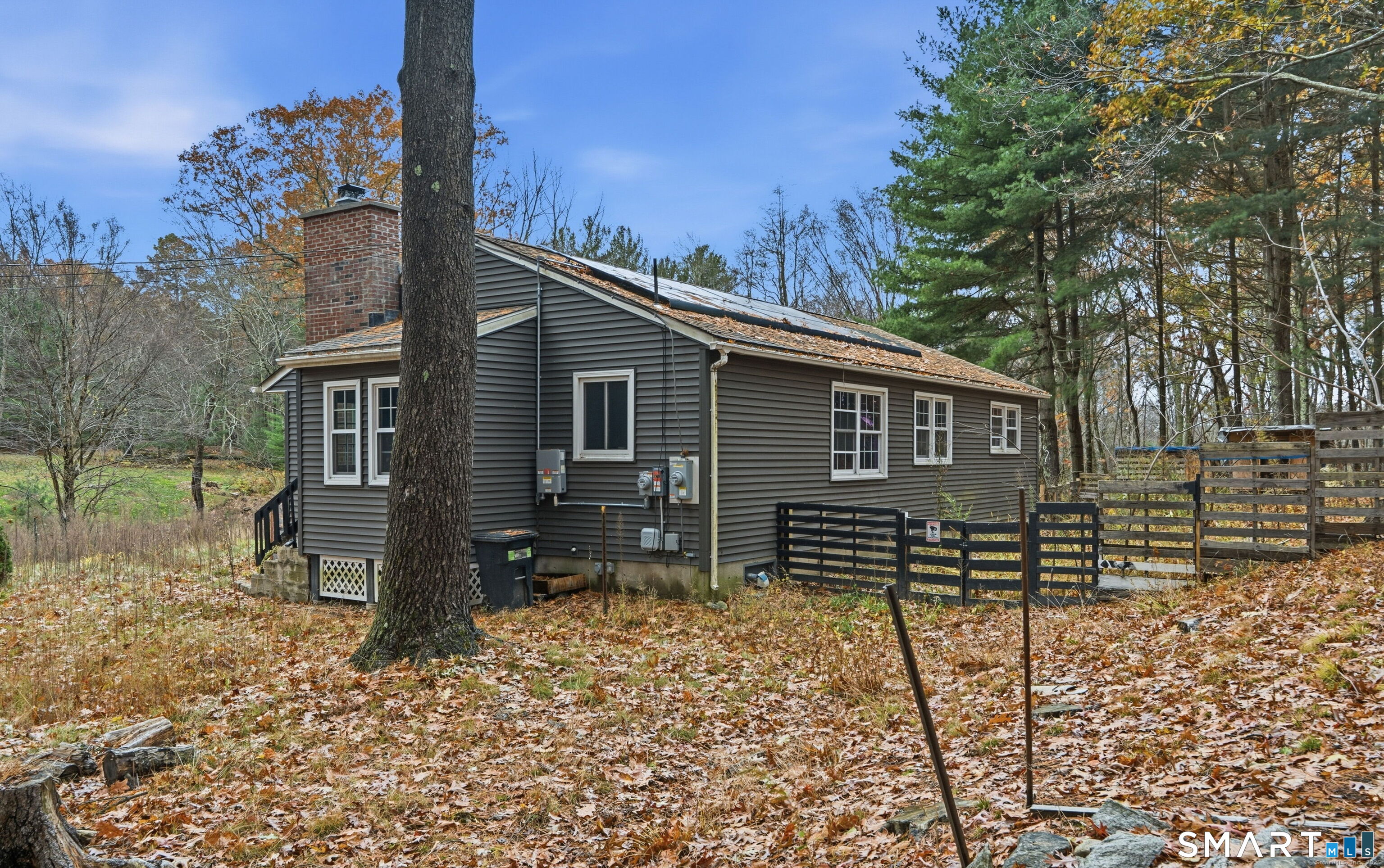 487 Buff Cap Road Tolland, CT 06084 - Photo 21 of 22 a view of a house with a yard and wooden fence
