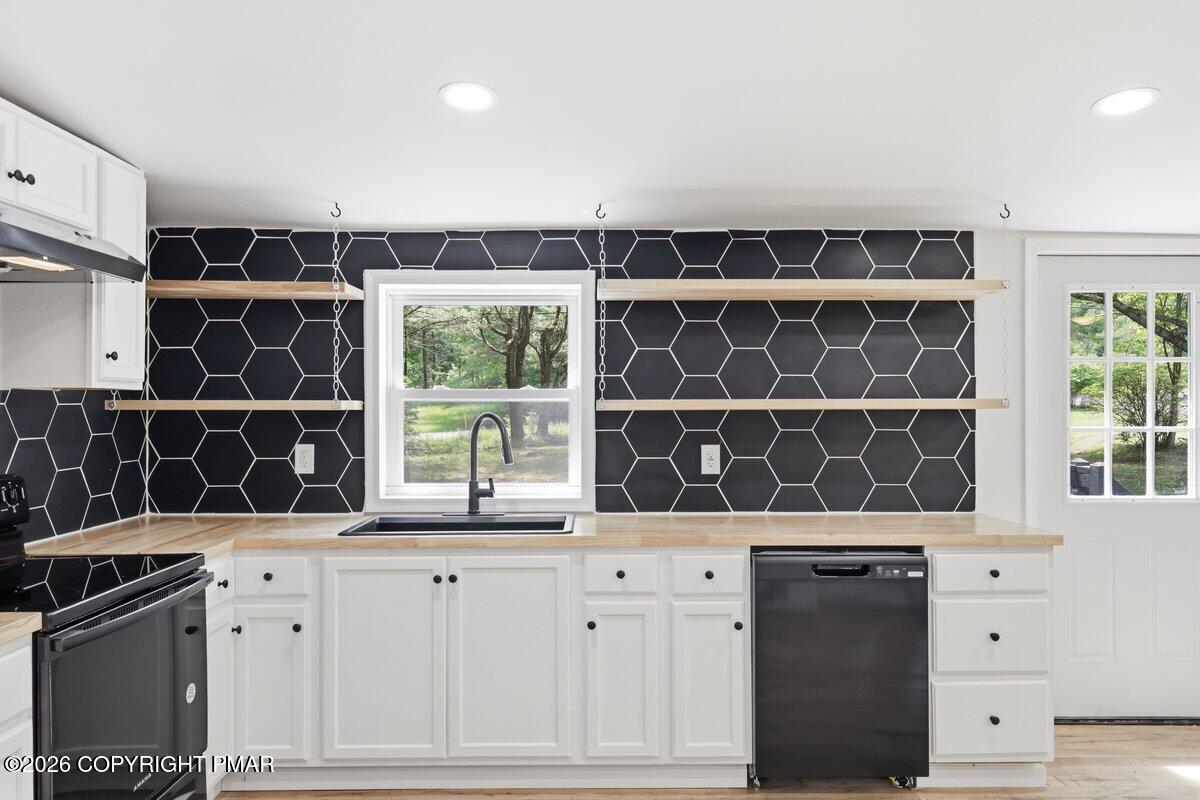 155 Blooming Grove Road Hawley, PA 18428 - Photo 15 of 41 a kitchen with granite countertop a stove a sink and a window