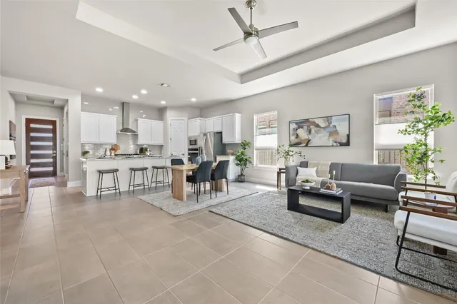 a living room with furniture and kitchen view