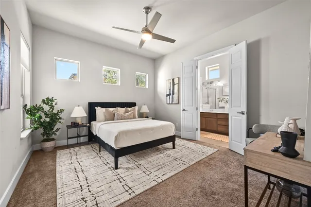 a spacious bedroom that has a bed and a table in it