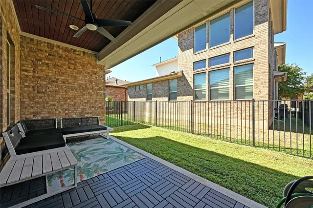 a view of a patio with couches chairs and wooden floor