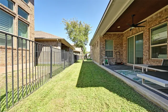 a view of a house with backyard and sitting area