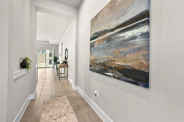 a view of a hallway view with large mirror and furniture