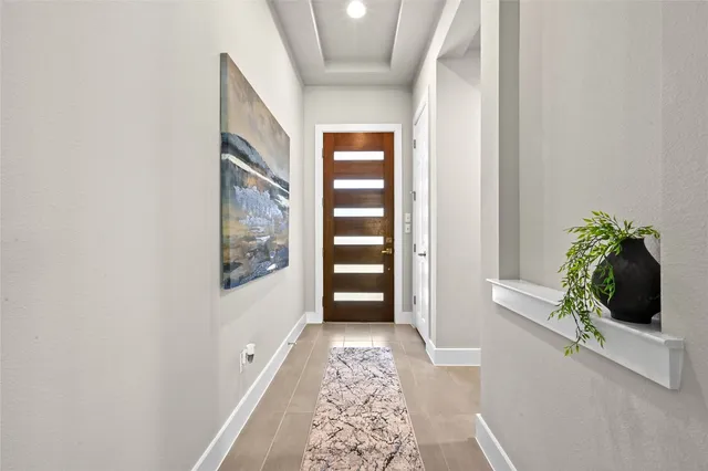 a view of hallway with stairs and wooden floor