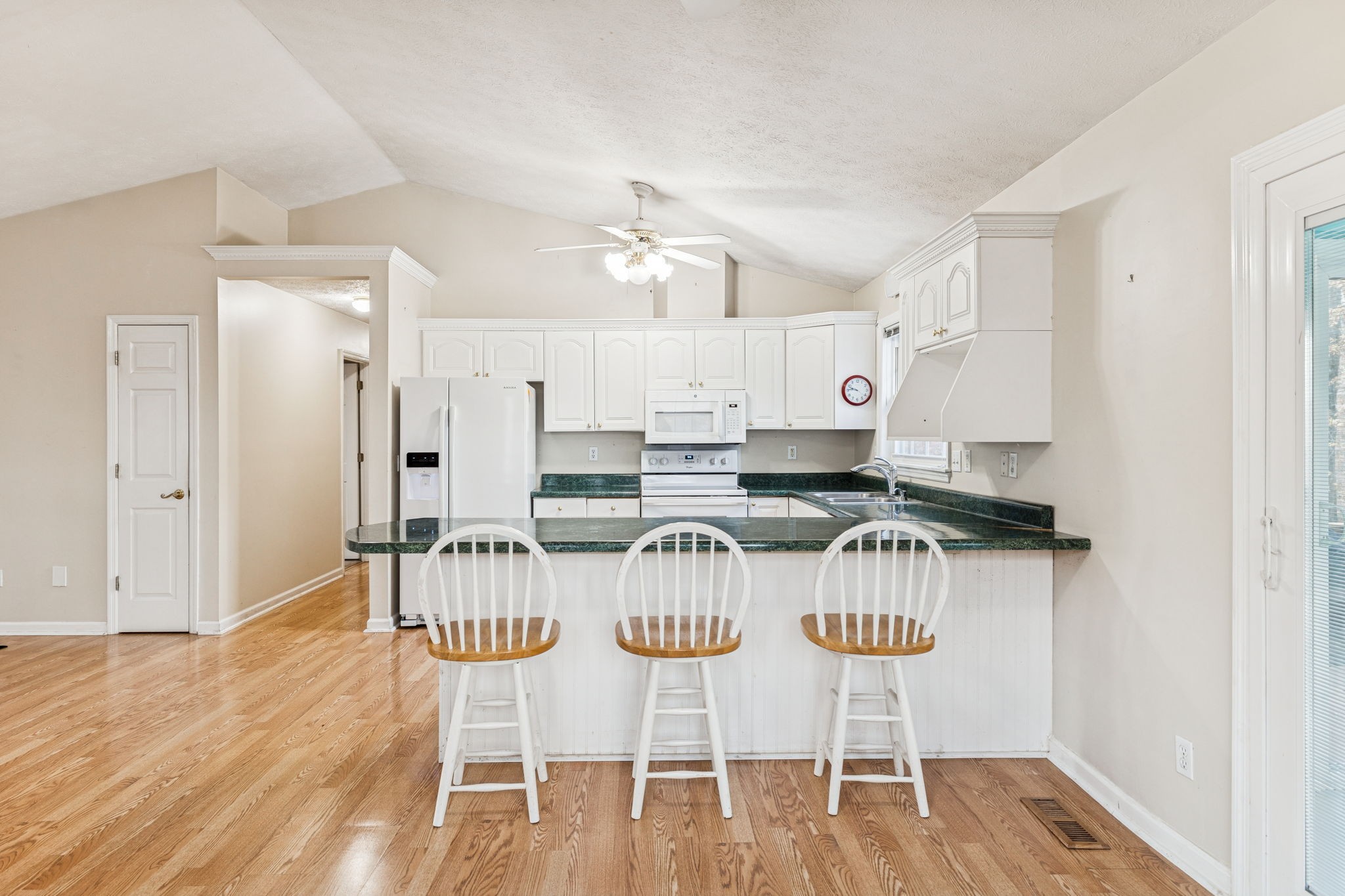 7399 Forest Glenn Road Fairview, TN 37062 - Photo 25 of 75 a kitchen with stainless steel appliances a dining table chairs and white cabinets