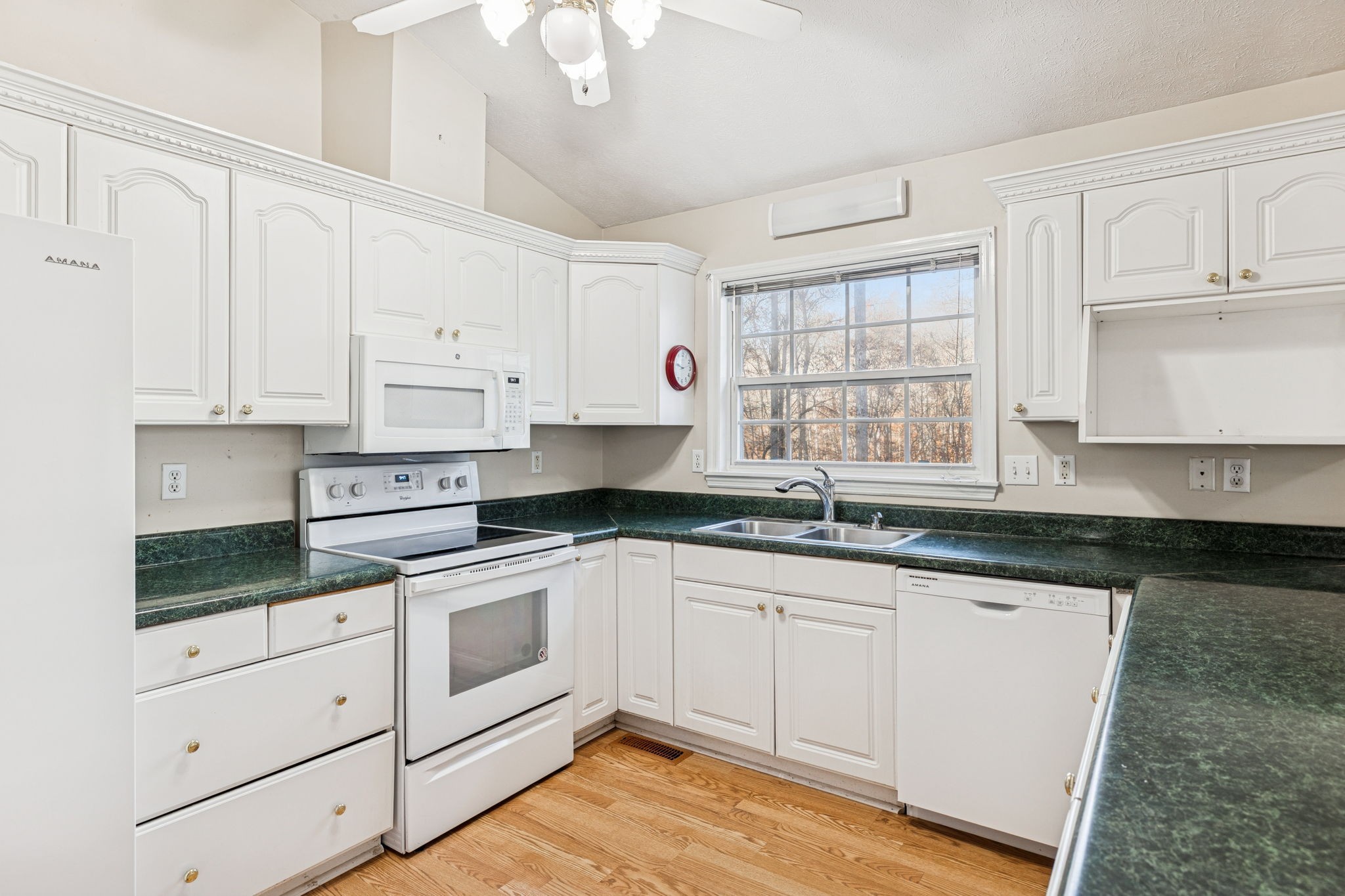 7399 Forest Glenn Road Fairview, TN 37062 - Photo 29 of 75 a kitchen with granite countertop white cabinets white appliances and sink