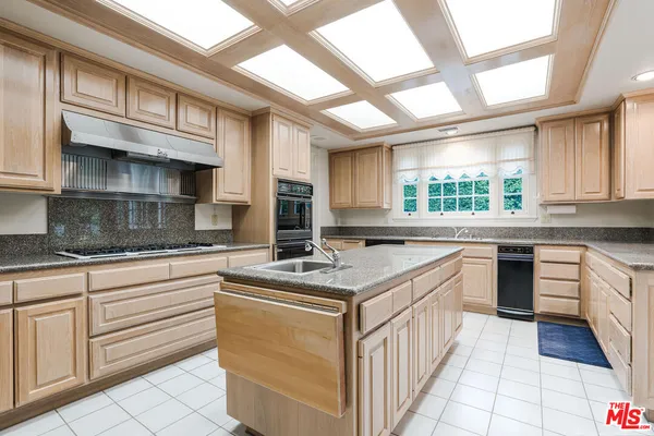 a kitchen with stainless steel appliances granite countertop a sink and cabinets