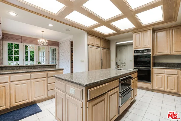 a kitchen with stainless steel appliances granite countertop a stove and a sink