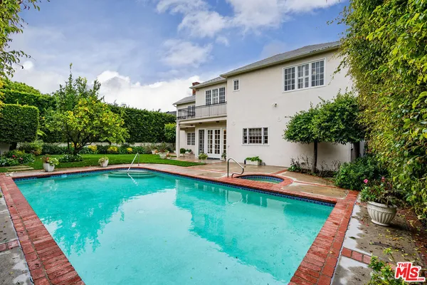 a house with swimming pool in front of it
