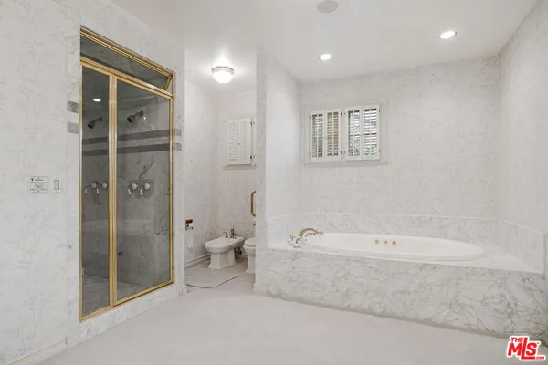 a spacious bathroom with a bathtub and shower
