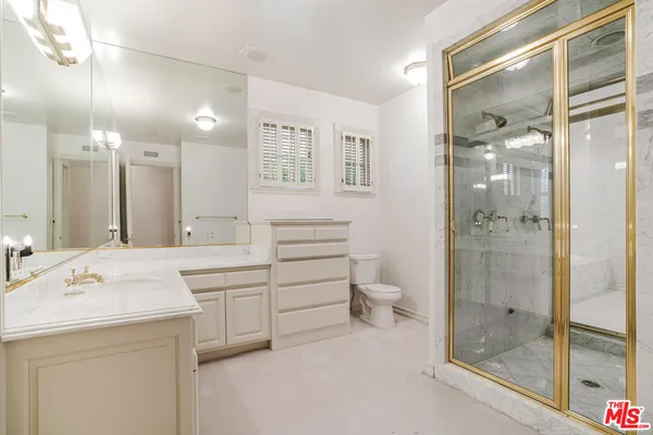 a bathroom with a shower sink and mirror