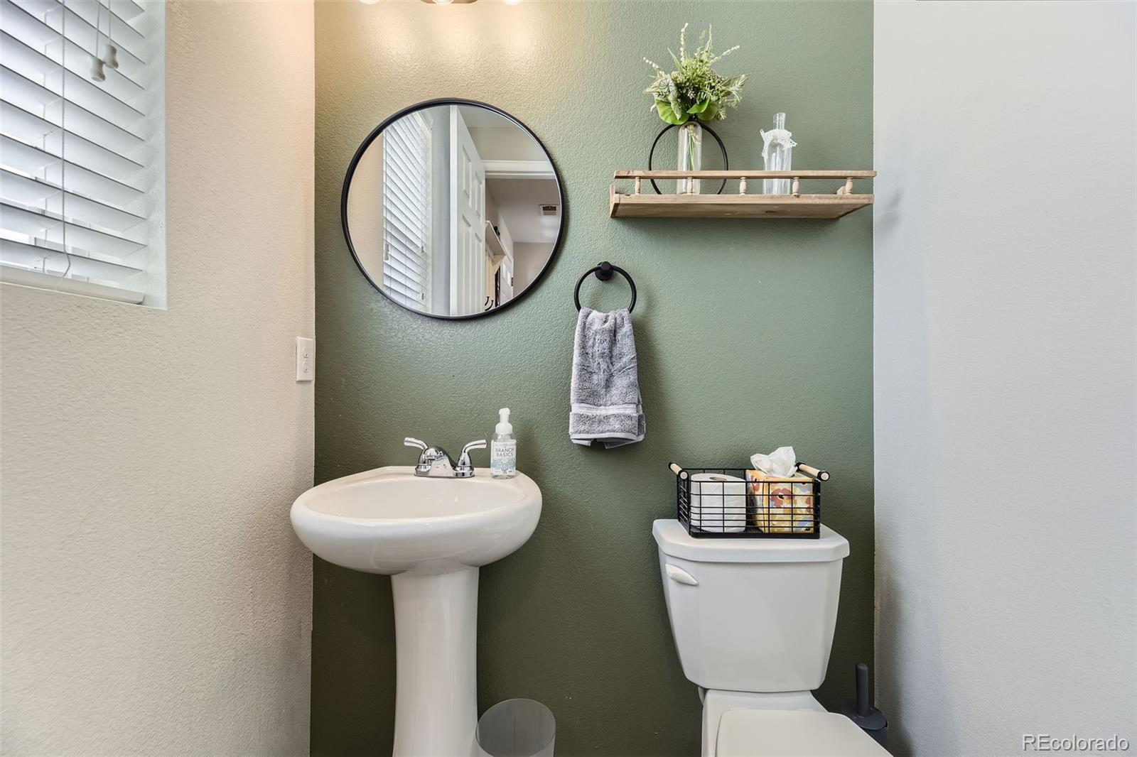 25621 East Cedar Place Aurora, CO 80018 - Photo 12 of 30 a bathroom with a toilet sink and mirror