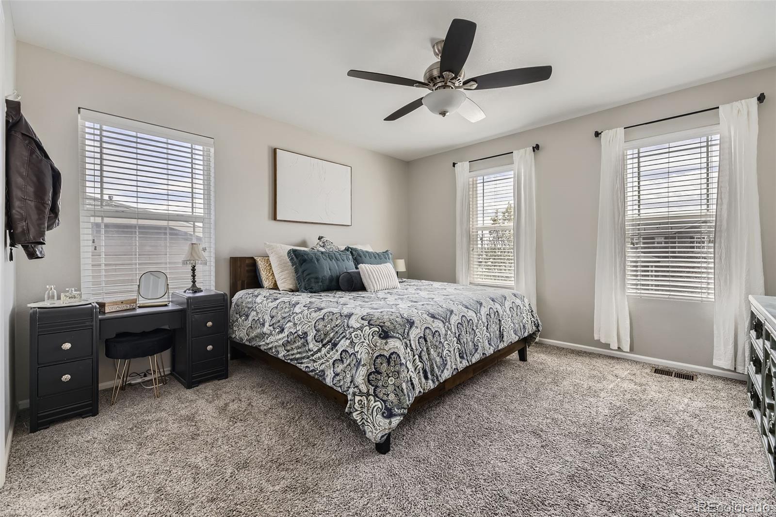 25621 East Cedar Place Aurora, CO 80018 - Photo 13 of 30 a bedroom with a large bed and a flat screen tv
