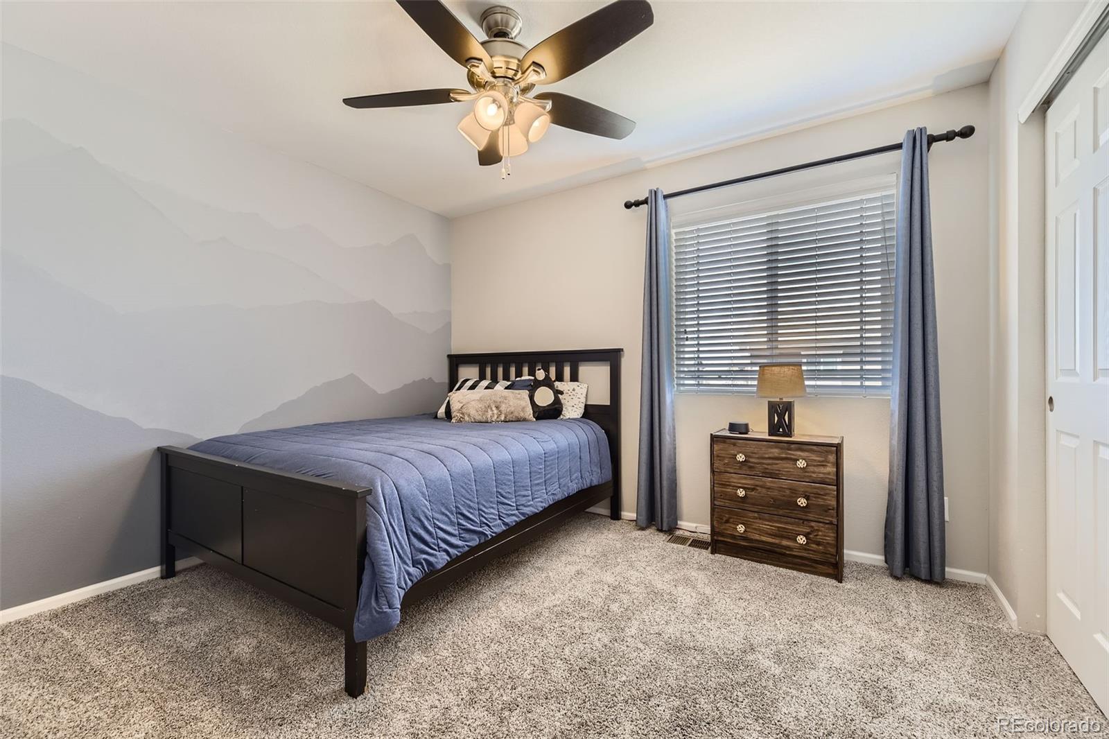 25621 East Cedar Place Aurora, CO 80018 - Photo 19 of 30 a bedroom with a bed dresser and a window