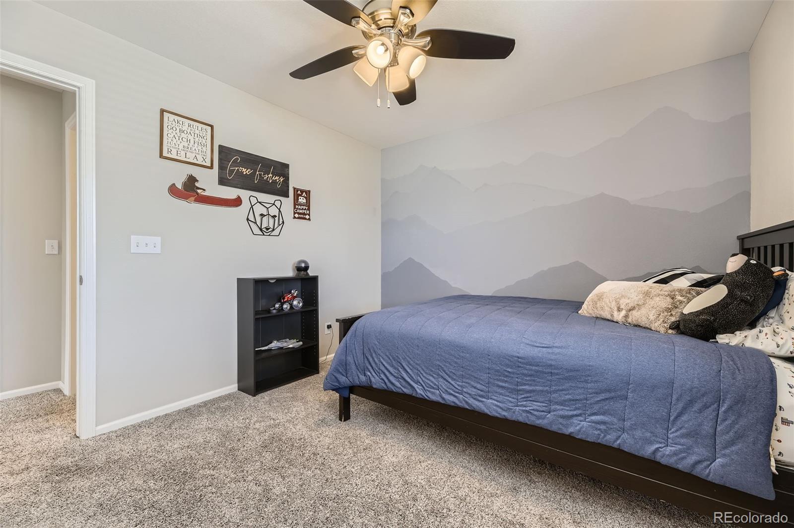 25621 East Cedar Place Aurora, CO 80018 - Photo 20 of 30 a bedroom with a bed and a chandelier