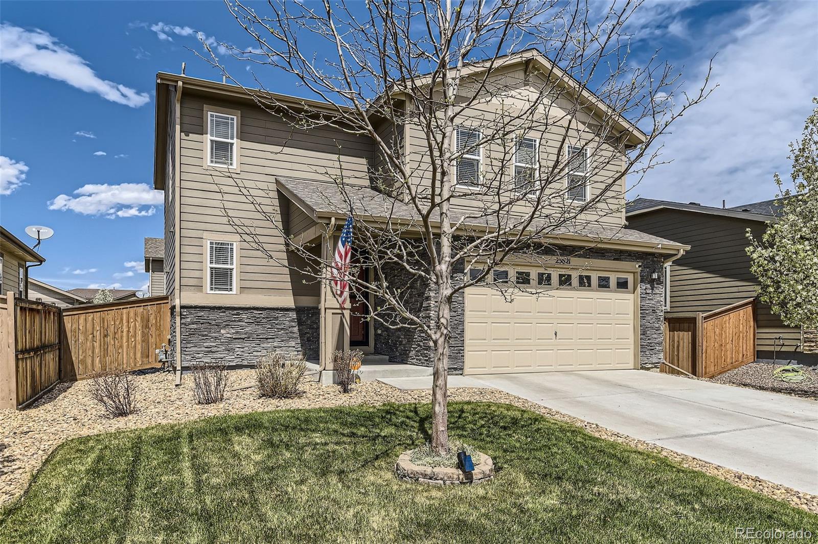 25621 East Cedar Place Aurora, CO 80018 - Photo 2 of 30 a front view of a house with garden