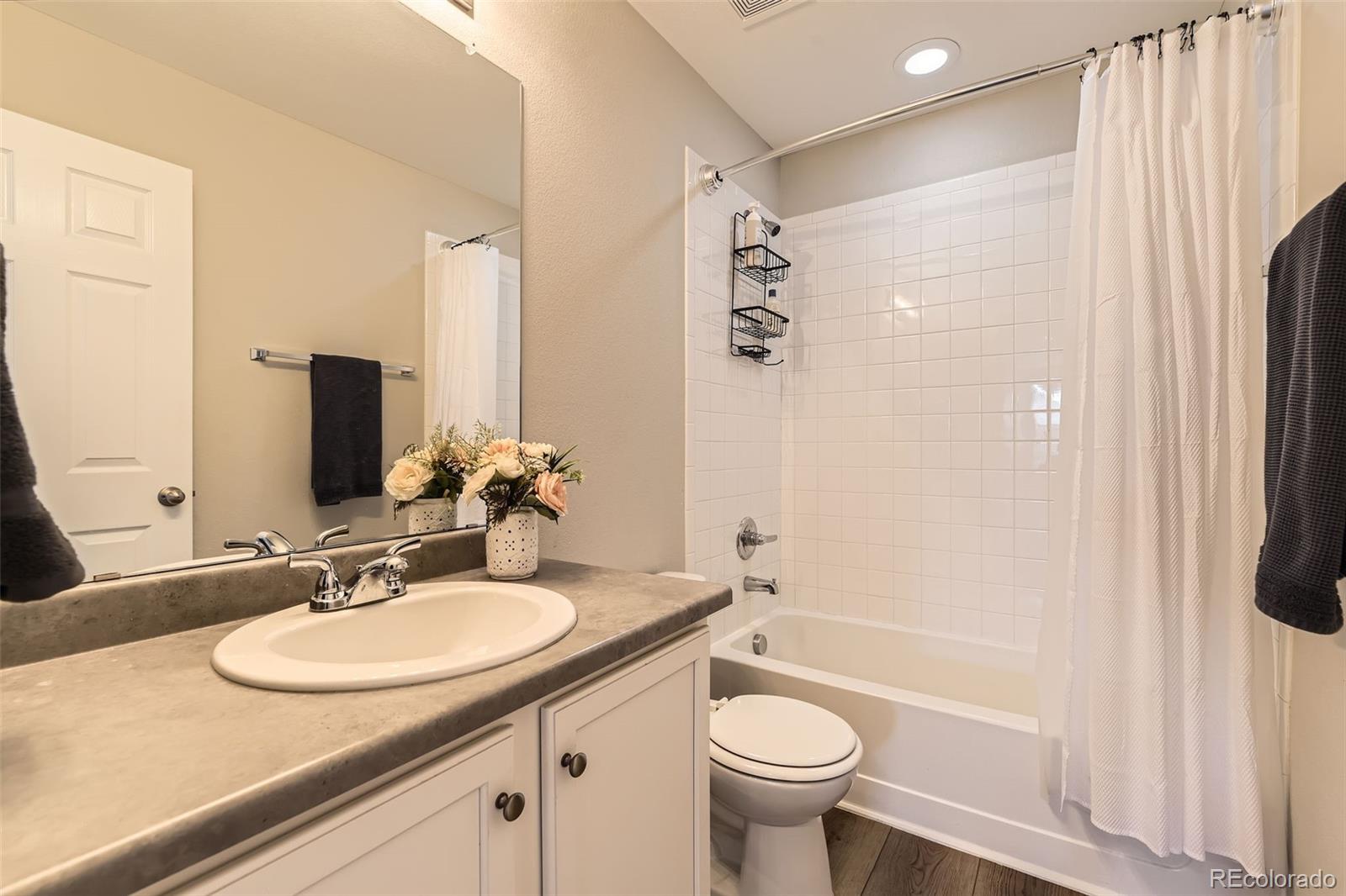 25621 East Cedar Place Aurora, CO 80018 - Photo 21 of 30 a bathroom with a sink a toilet and shower
