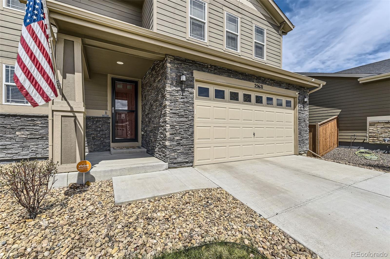 25621 East Cedar Place Aurora, CO 80018 - Photo 3 of 30 a front view of a house with a garage
