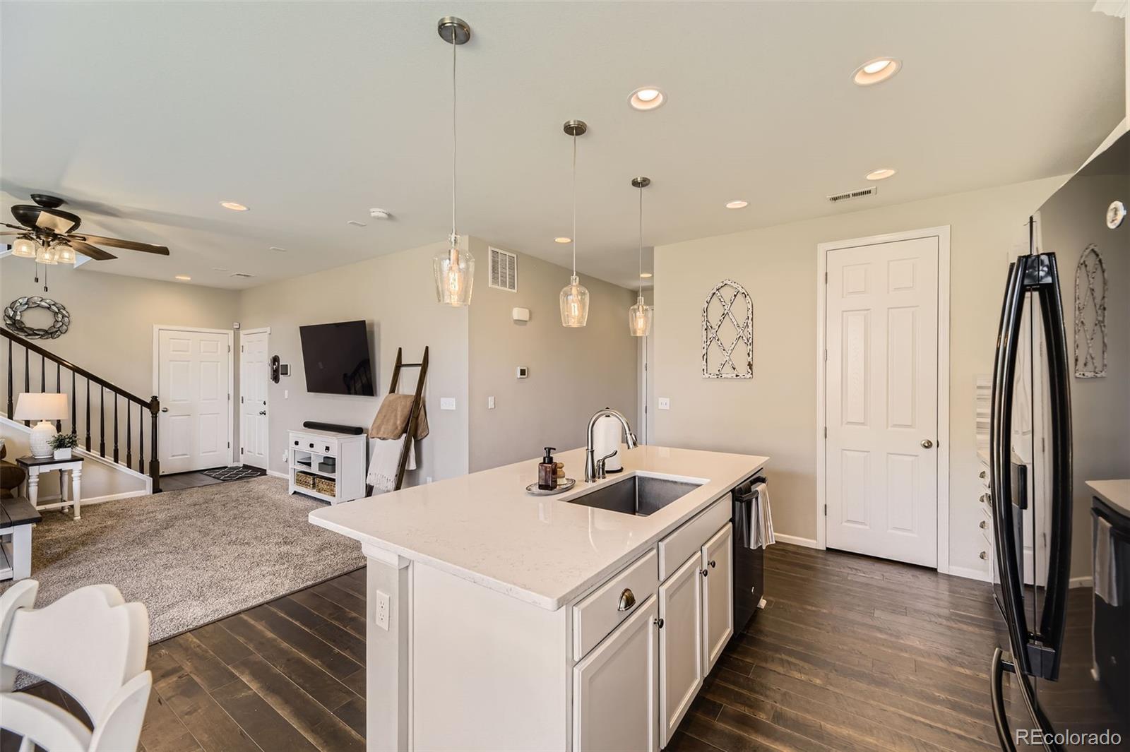 25621 East Cedar Place Aurora, CO 80018 - Photo 5 of 30 a kitchen with sink stove and refrigerator