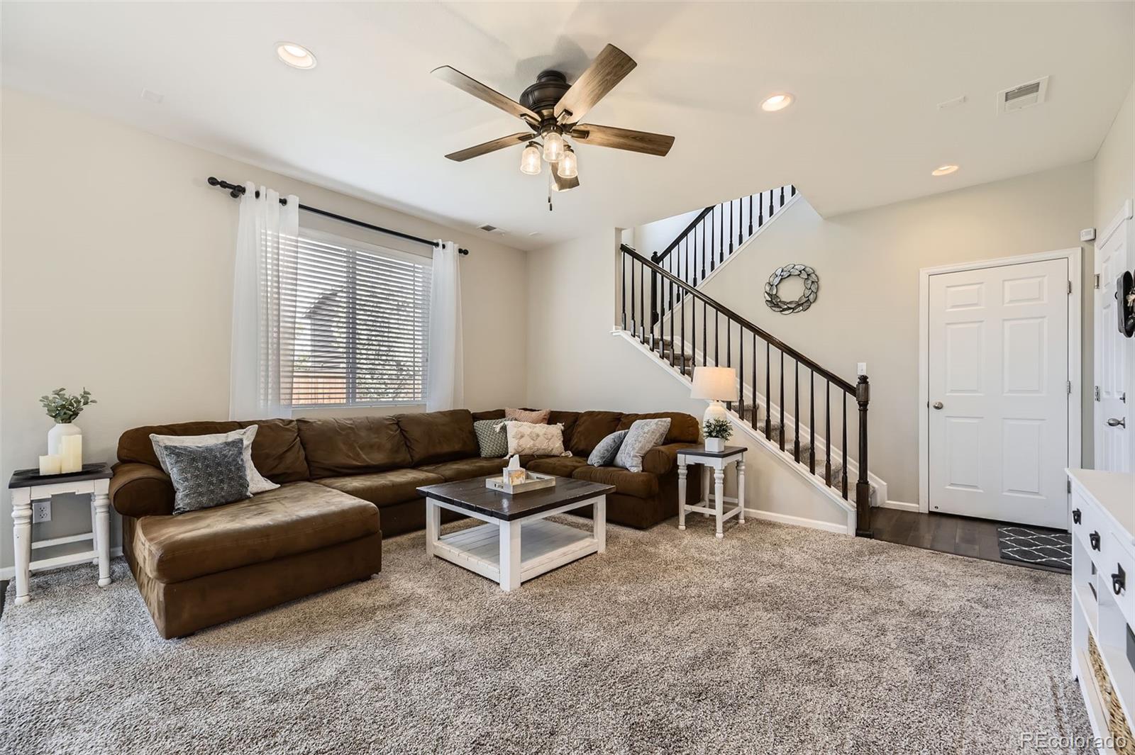 25621 East Cedar Place Aurora, CO 80018 - Photo 9 of 30 a living room with furniture and a ceiling fan