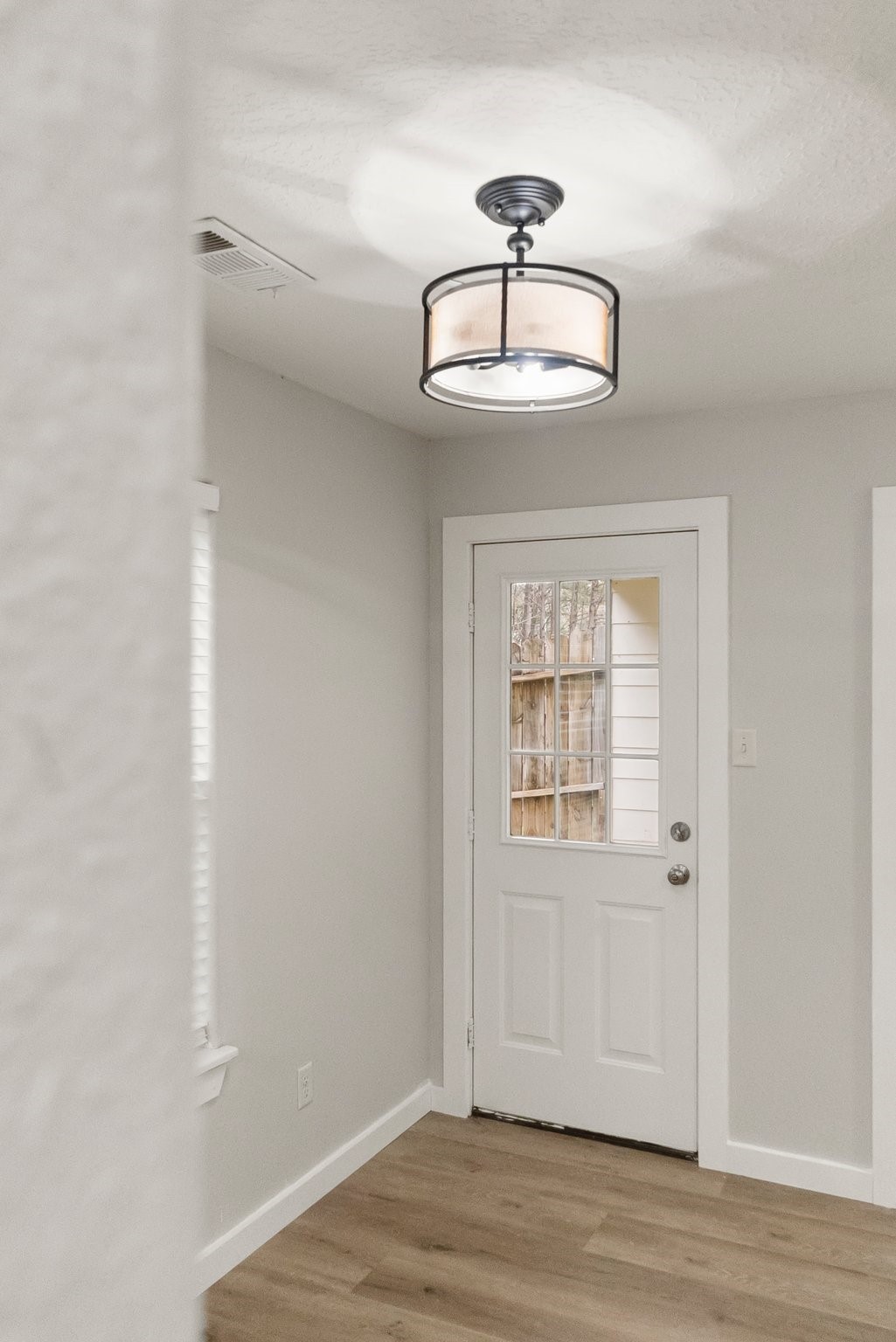 1799 League Line Road, Unit 4 Conroe, TX 77304 - Photo 13 of 34 a view of an empty room with wooden floor and a window